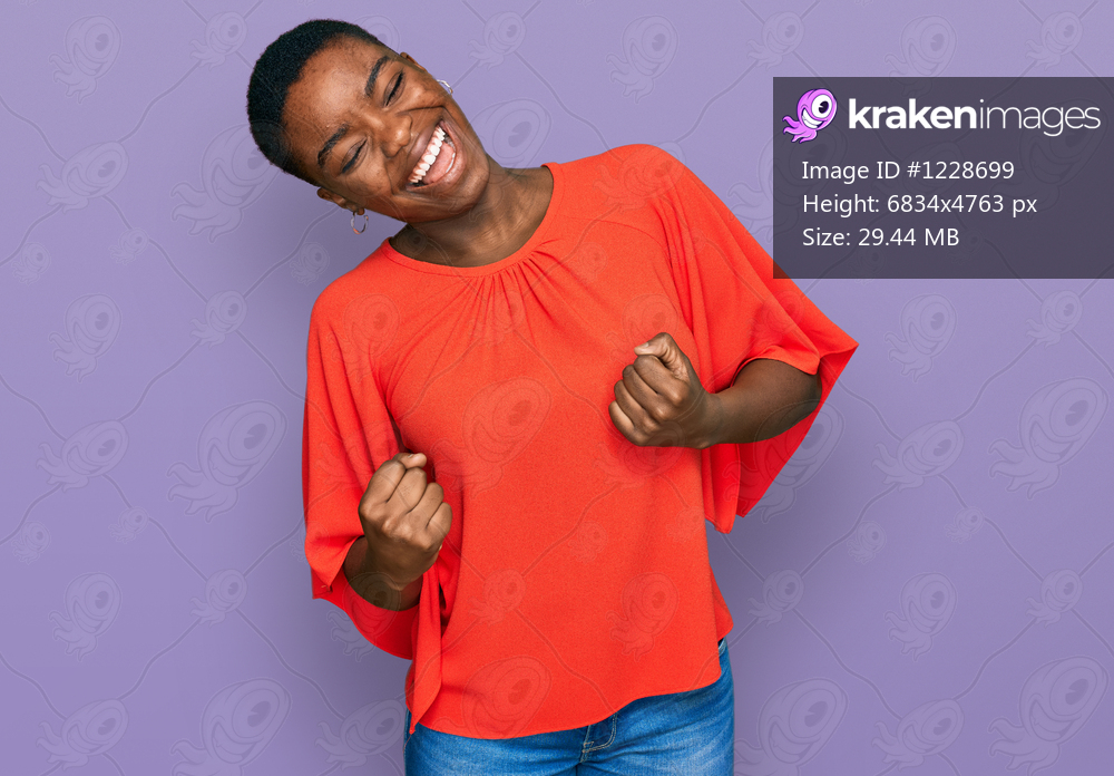 Young african american woman wearing casual clothes very happy and excited doing winner gesture with arms raised, smiling and screaming for success. celebration concept. 