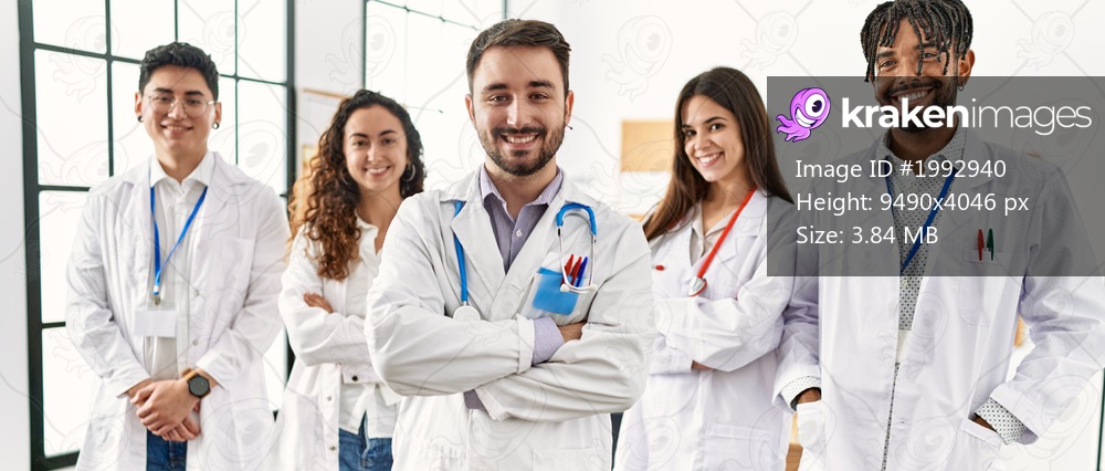 Group of young doctor smiling happy standing with arms crossed gesture at the clinic office.