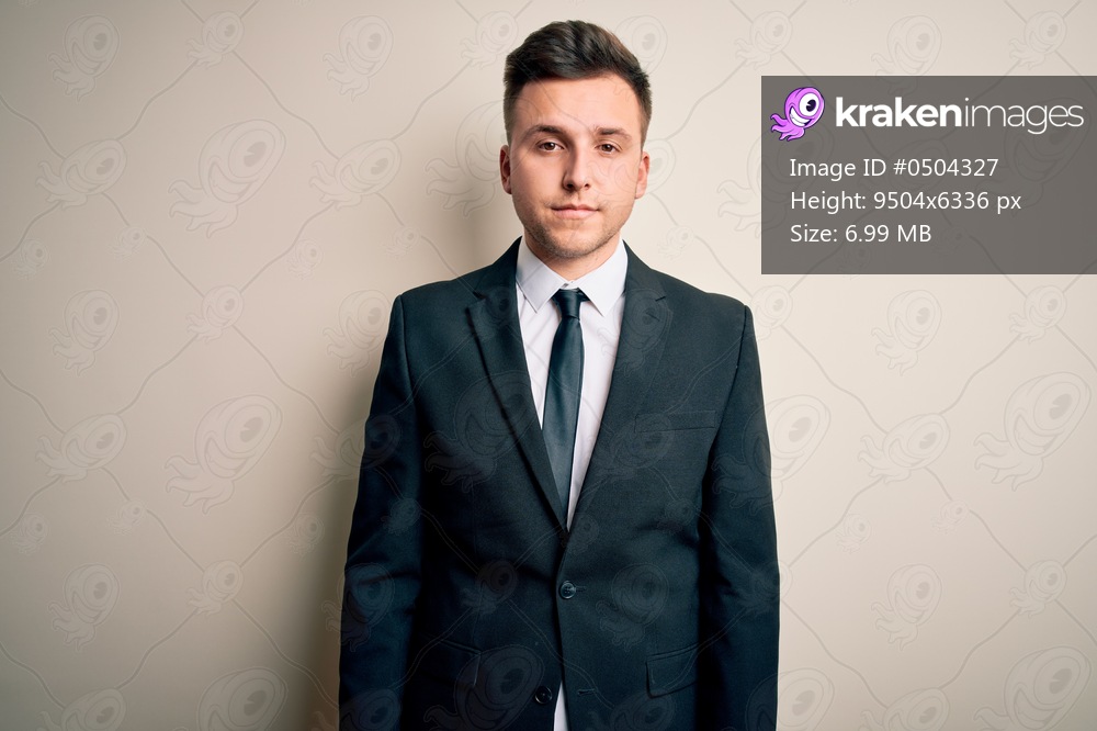 Young handsome business man wearing elegant suit and tie over isolated background looking sleepy and tired, exhausted for fatigue and hangover, lazy eyes in the morning.