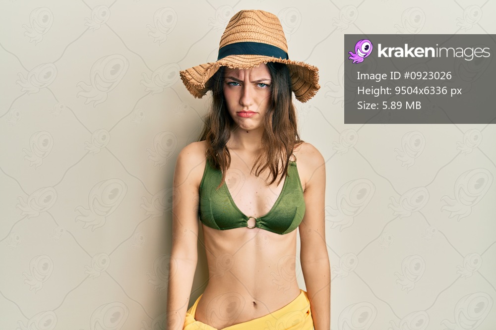Young brunette woman wearing bikini skeptic and nervous, frowning upset because of problem. negative person. 