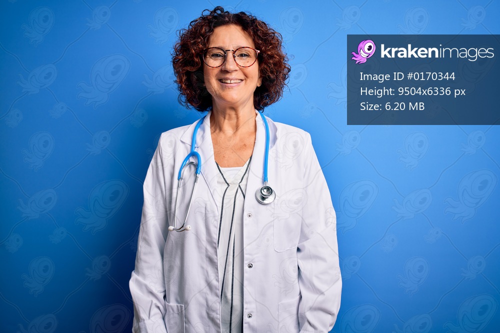 Middle Age Curly Hair Doctor Woman Wearing Coat And Stethoscope Over Blue Background With A