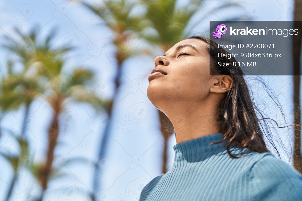 Young african american woman breathing at park
