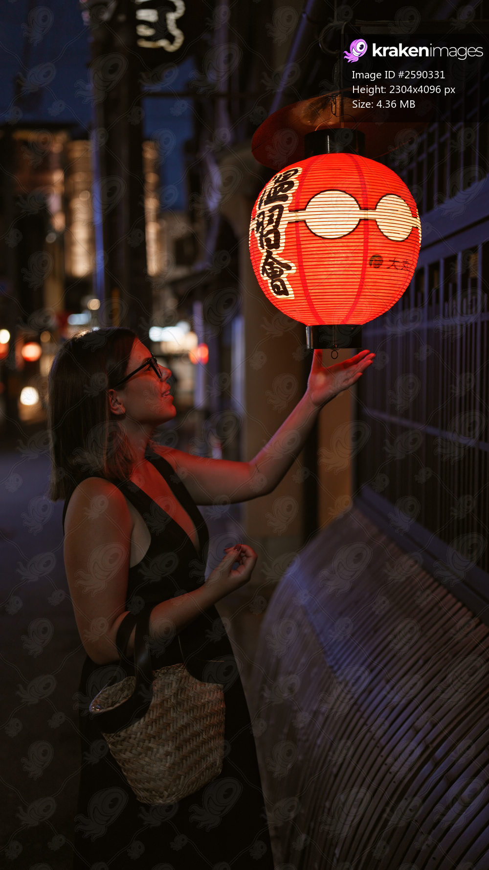Cheerful hispanic woman sporting glasses on kyoto streets, engaging with rich asian culture by touching traditional japanese lanterns under city lights, experiencing a vibrant asian night.