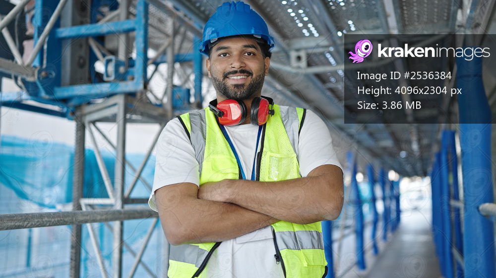 African american man builder smiling confident standing with arms crossed gesture at street