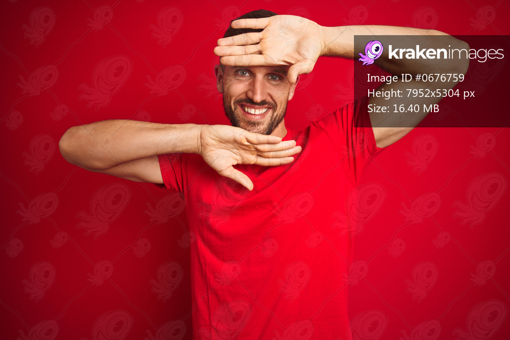Young handsome man wearing casual t-shirt over red isolated background Smiling cheerful playing peek a boo with hands showing face. Surprised and exited