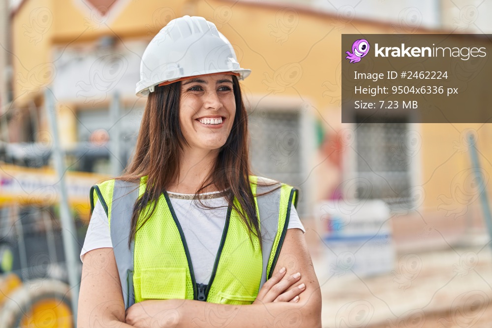 Young beautiful hispanic woman architect smiling confident standing with arms crossed gesture at street