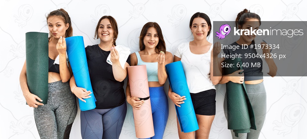 Group of women holding yoga mat standing over isolated background doing money gesture with hands, asking for salary payment, millionaire business 
