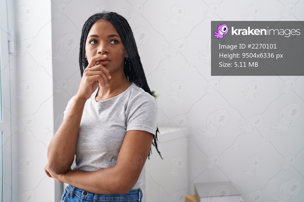 African american woman standing with worried expression at home