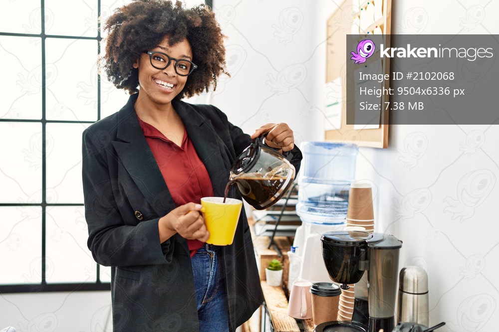Young african american woman smiling confident pouring coffee at office