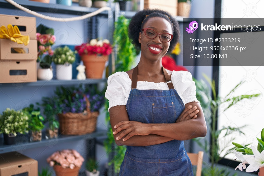African american woman florist smiling confident standing with arms crossed gesture at florist store