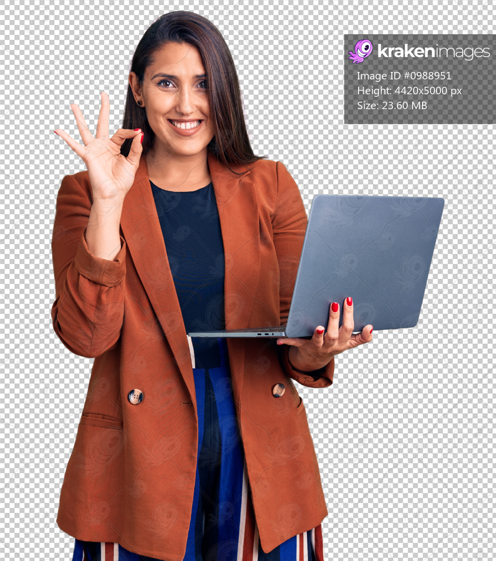 Young beautiful brunette woman using laptop doing ok sign with fingers, smiling friendly gesturing excellent symbol