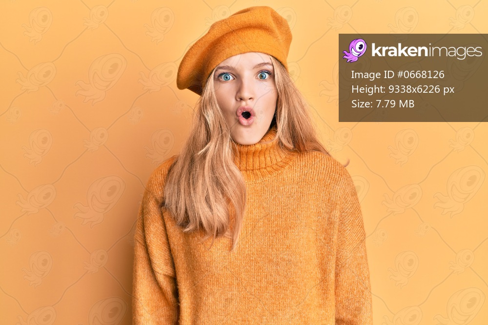 Beautiful young caucasian girl wearing french look with beret afraid and shocked with surprise expression, fear and excited face. 