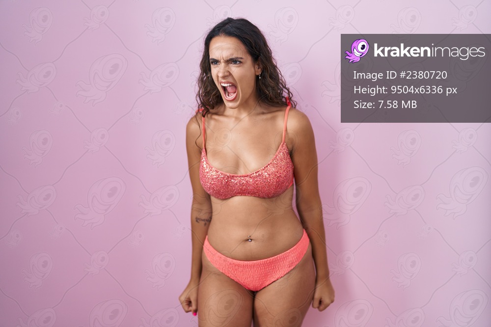 Young hispanic woman wearing lingerie over pink background angry