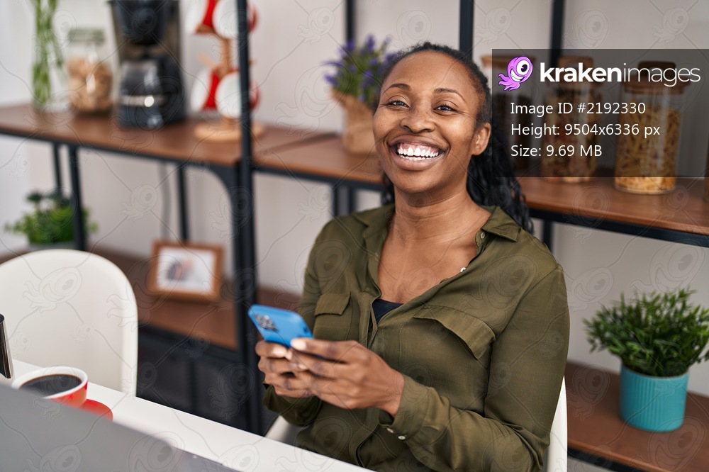 African american woman smiling confident using smartphone at home