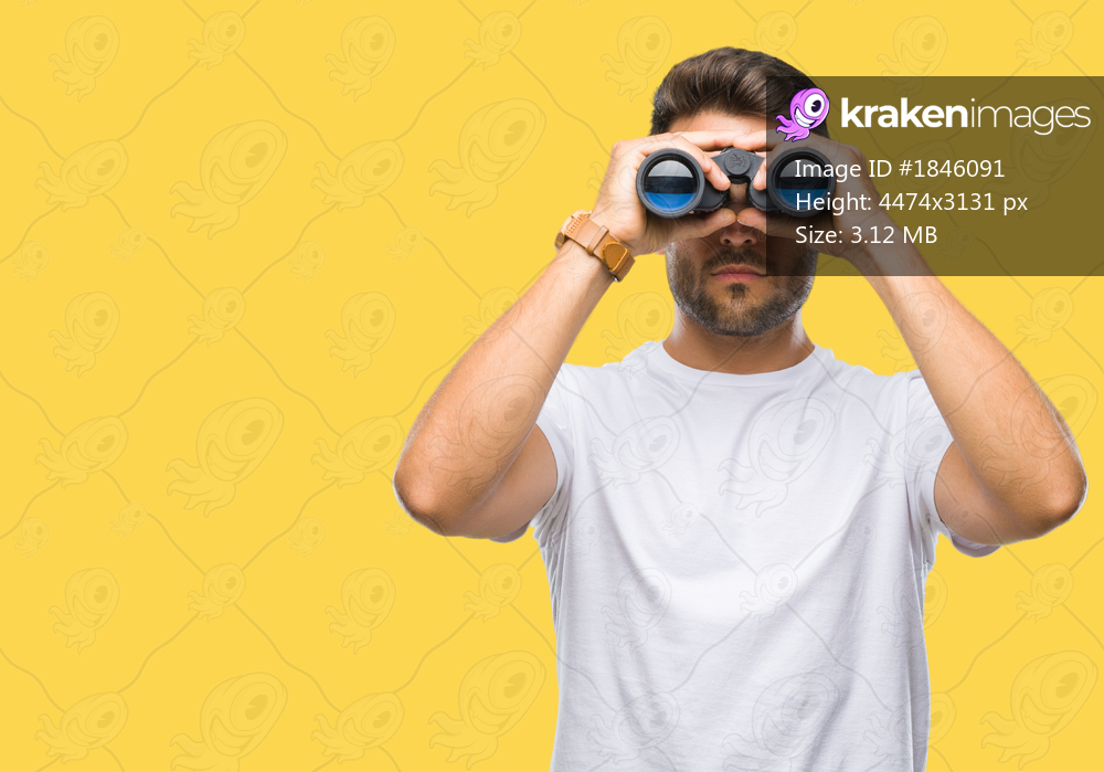 Young handsome man looking through binoculars over isolated background with a confident expression on smart face thinking serious